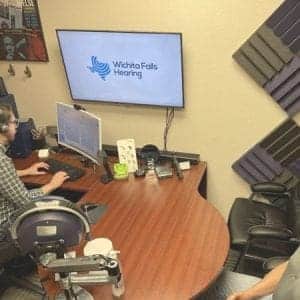 A man has his hearing aids reprogrammed at wichita falls hearing.